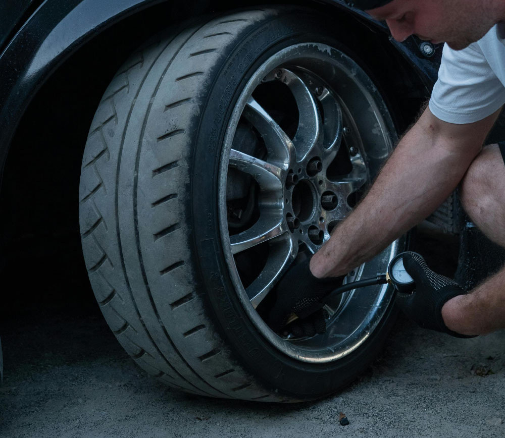 Technician changing a flat tire