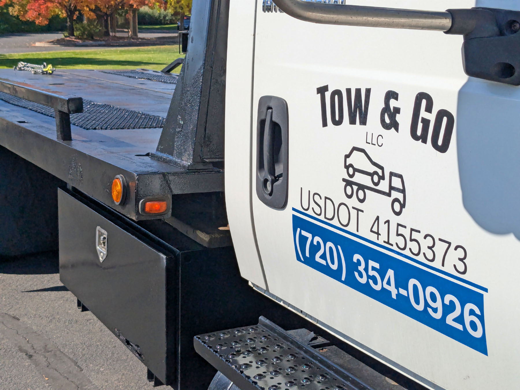 Side door of tow truck with company logo