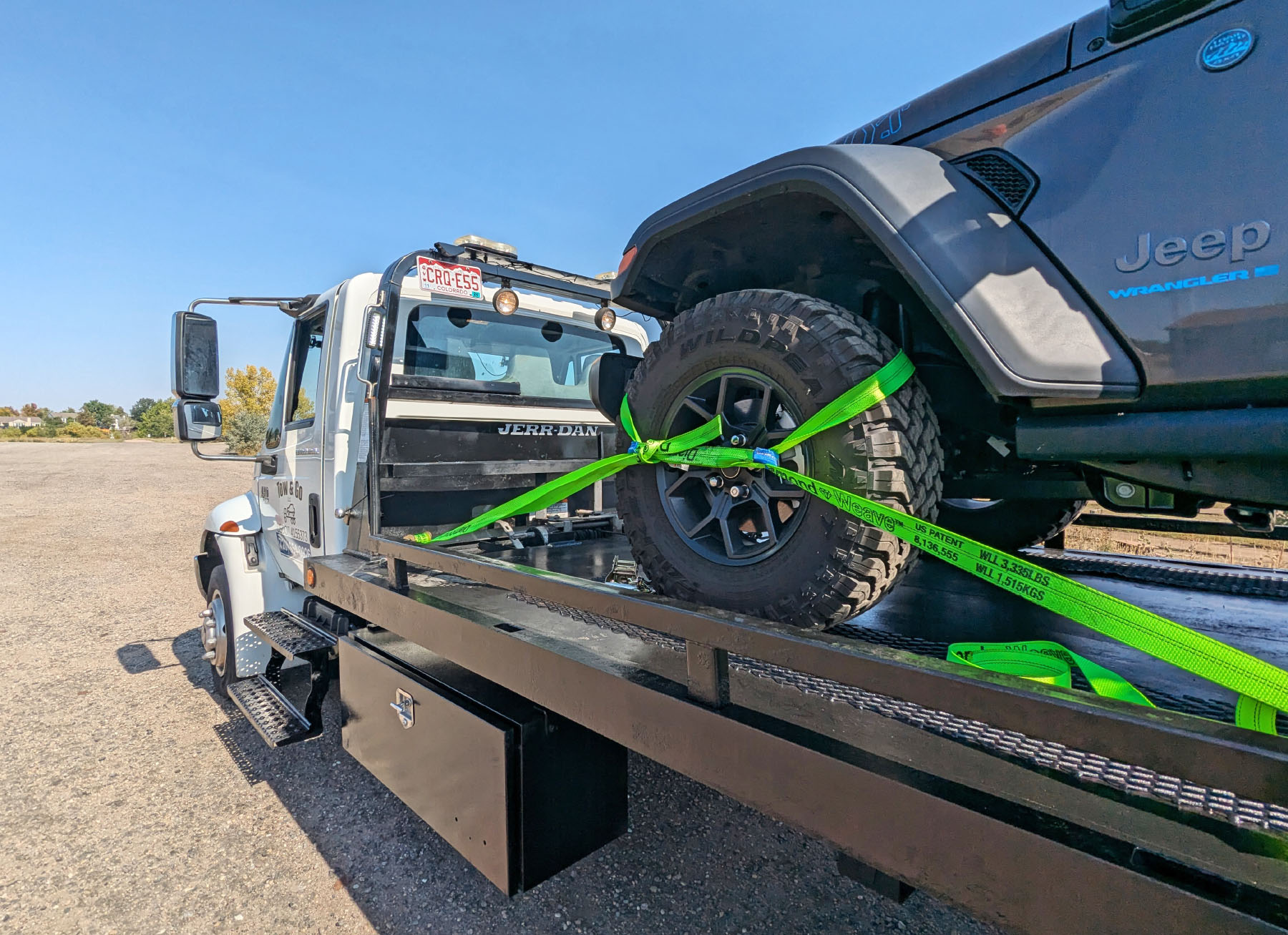 Tow truck towing a vehicle using stripes